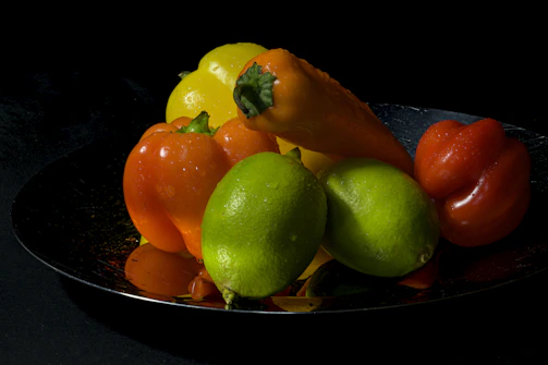 Elegant dark-toned image of fresh frozen fruits and vegetables with soft gold accents.