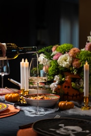 A cozy table setting with seasonal decorations and gourmet Italian dishes ready to be served.