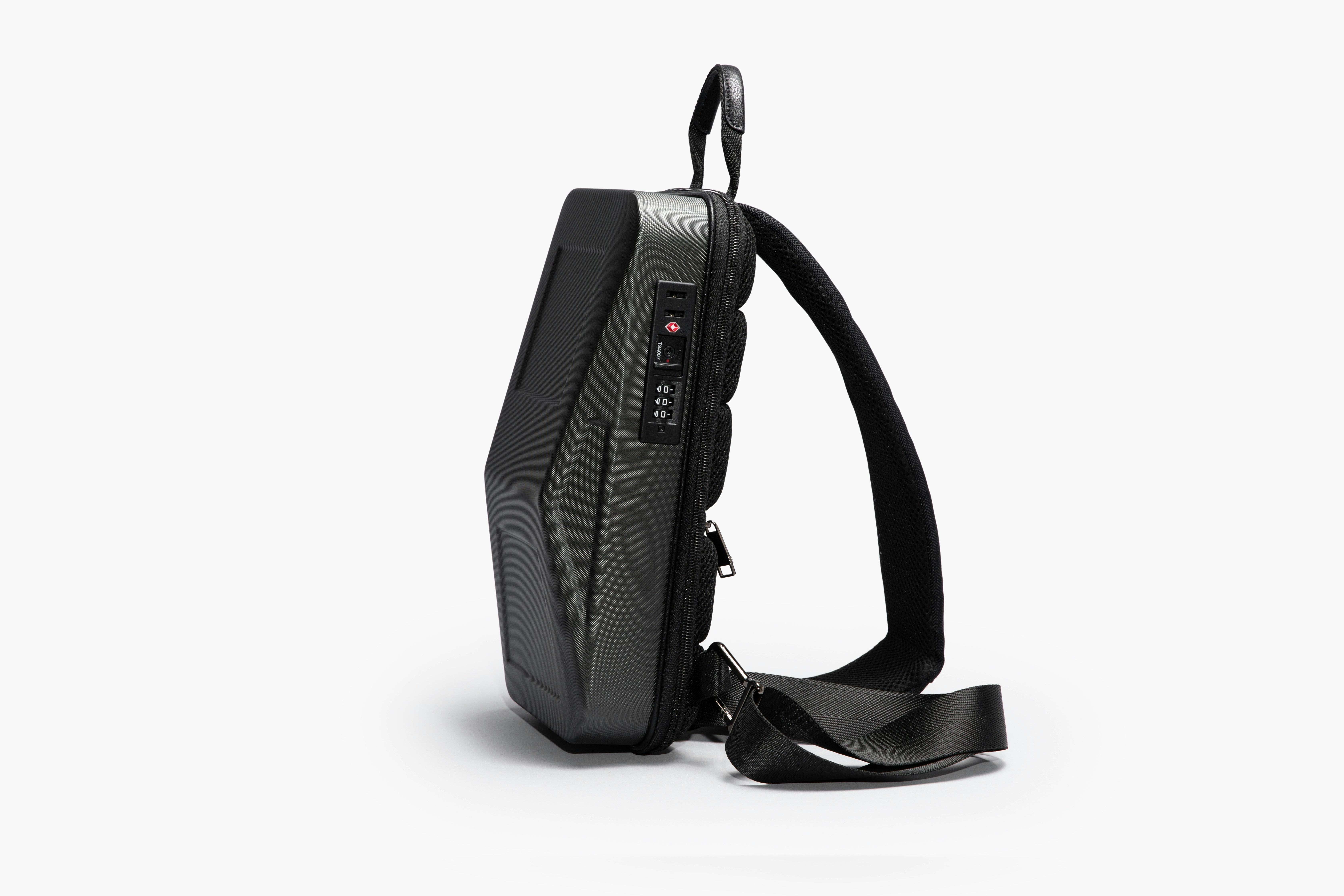 a black and silver computer mouse, Cybersling Tesla Cybertruck Crossbody sling bag mini backpack by Cyberbackpack.com. Side view. Crossbody bags are in. CyberSling is a multi-functional and multi-purpose crossbody backpack shoulder bag with a USB charging port and anti-theft features. With the TSA passcode locking zippers and adjustable straps, CyberSling can serve as your crossbody backpack purse and can be worn as a chest bag, or a convertible backpack crossbody bag. This mini crossbody backpack for men and women has one large easy-to-reach compartment with plenty of room for your gadgets, books, daily use items, etc.