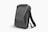 A sleek, black, hard-shell backpack with an ergonomic design. The front panel features distinct geometric patterns and a combination lock. The backpack has adjustable shoulder straps and a streamlined appearance, suitable for modern, urban settings.