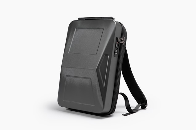 A sleek, black, hard-shell backpack with an ergonomic design. The front panel features distinct geometric patterns and a combination lock. The backpack has adjustable shoulder straps and a streamlined appearance, suitable for modern, urban settings.