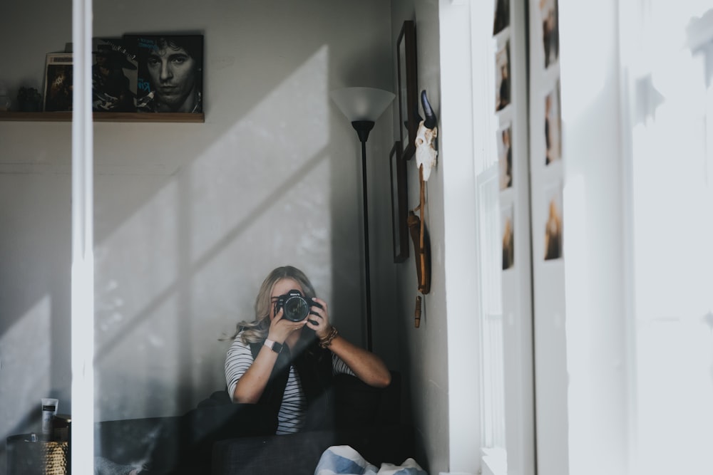 a person taking a picture of herself in a mirror