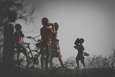 Outdoor scene of children playing, framed with a clean, airy aesthetic emphasizing light and movement.