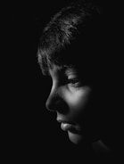 Modern portrait photo with strong black background and white accents.