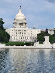 a large white building with a dome and a statue in front of it