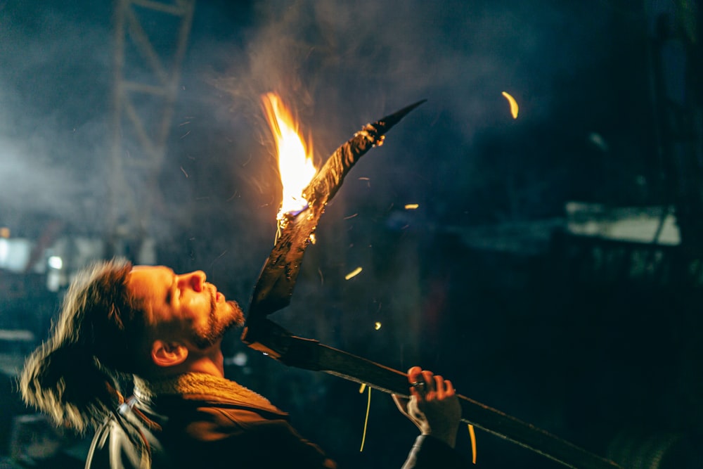 a person holding a stick with fire
