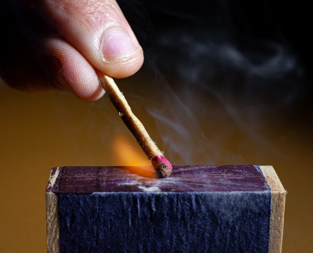 a person lighting a match