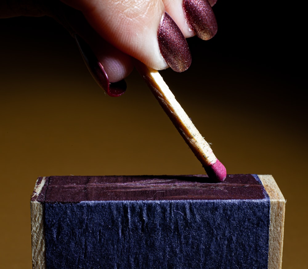 a person cutting a piece of wood