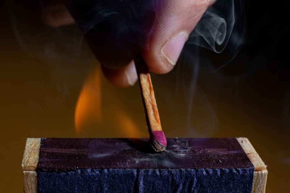 a person lighting a match