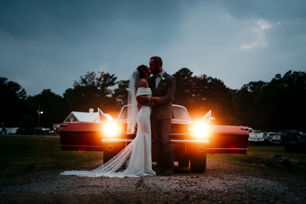 a man and woman kissing in front of a fire