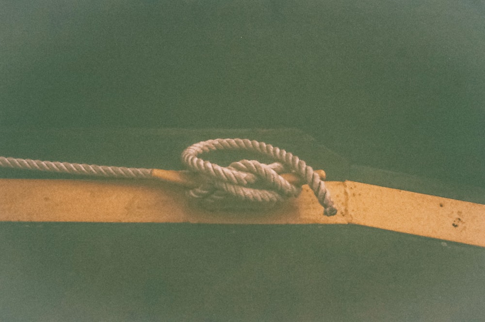 a white rope on a wooden surface