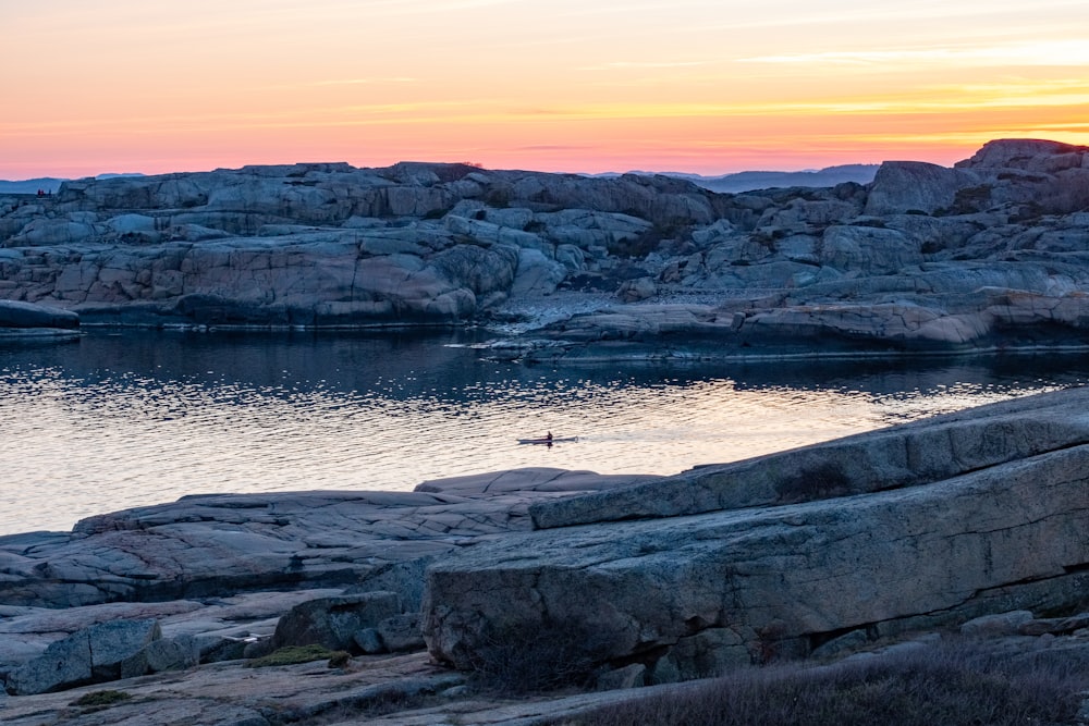 a rocky beach with a sunset