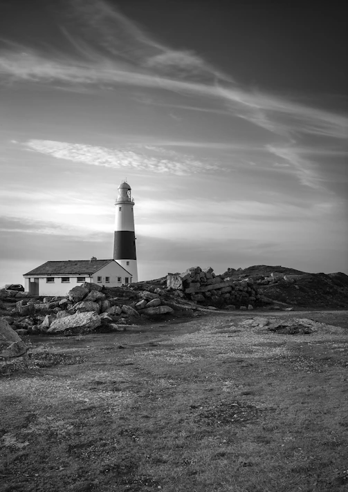 a lighthouse on a rocky hill