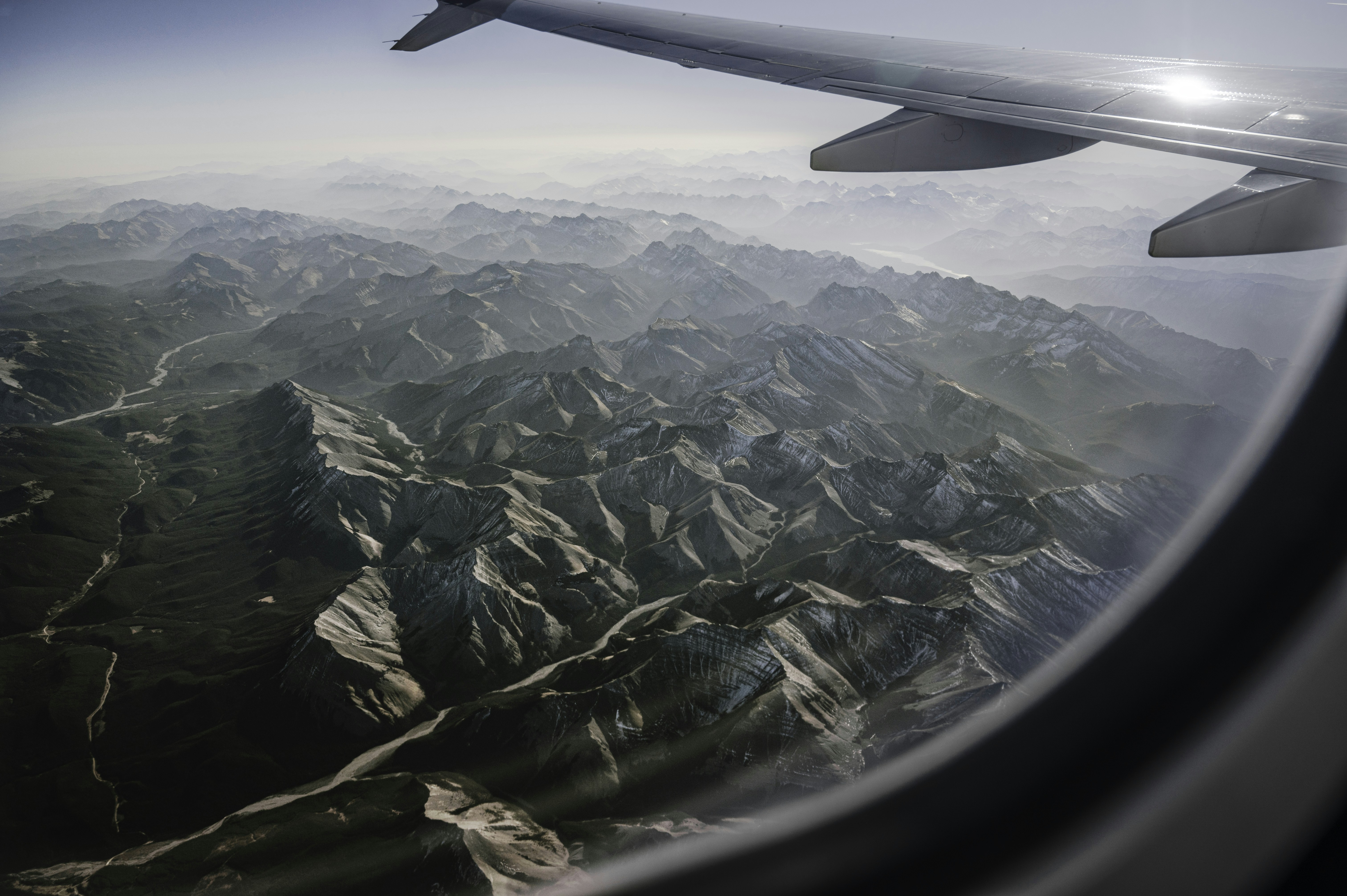 an airplane wing over a mountain range, 𖤥 Canadian Rockies