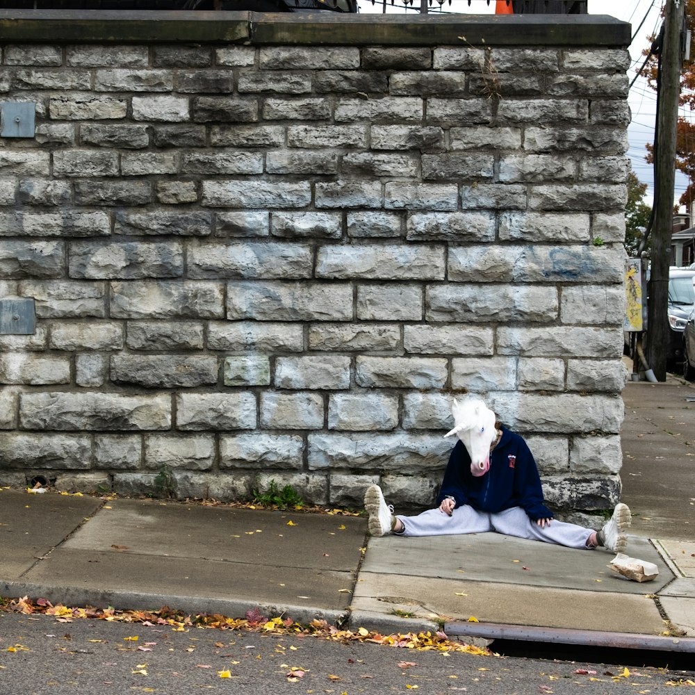 a person sitting on the sidewalk