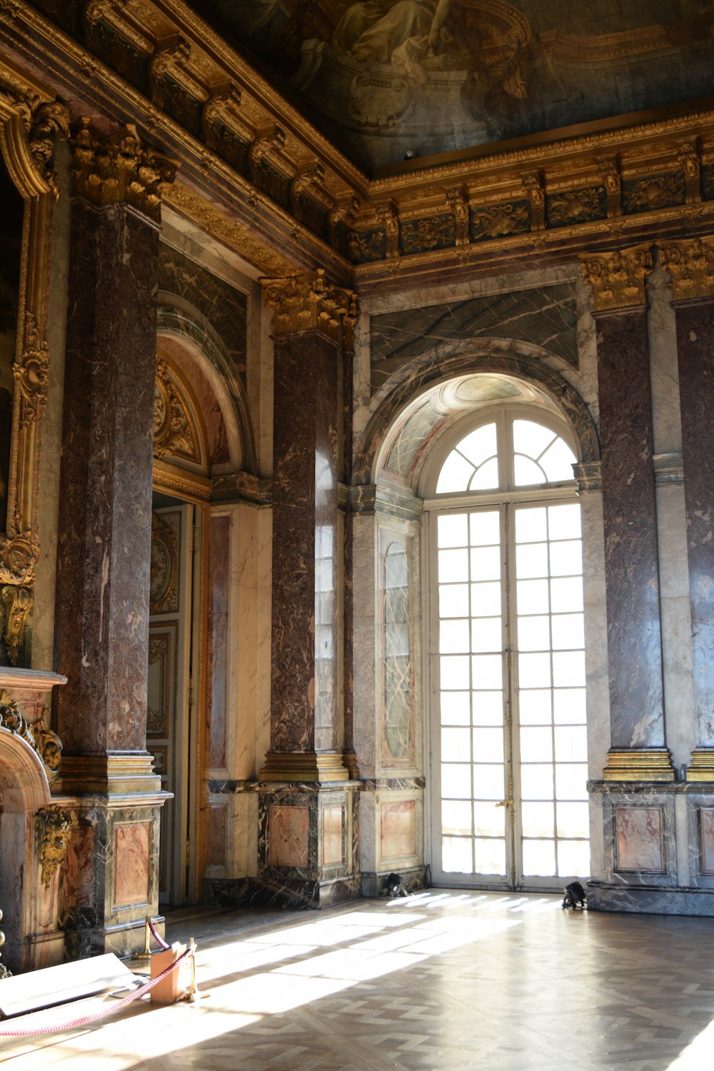 a room with a large window and a large arched doorway