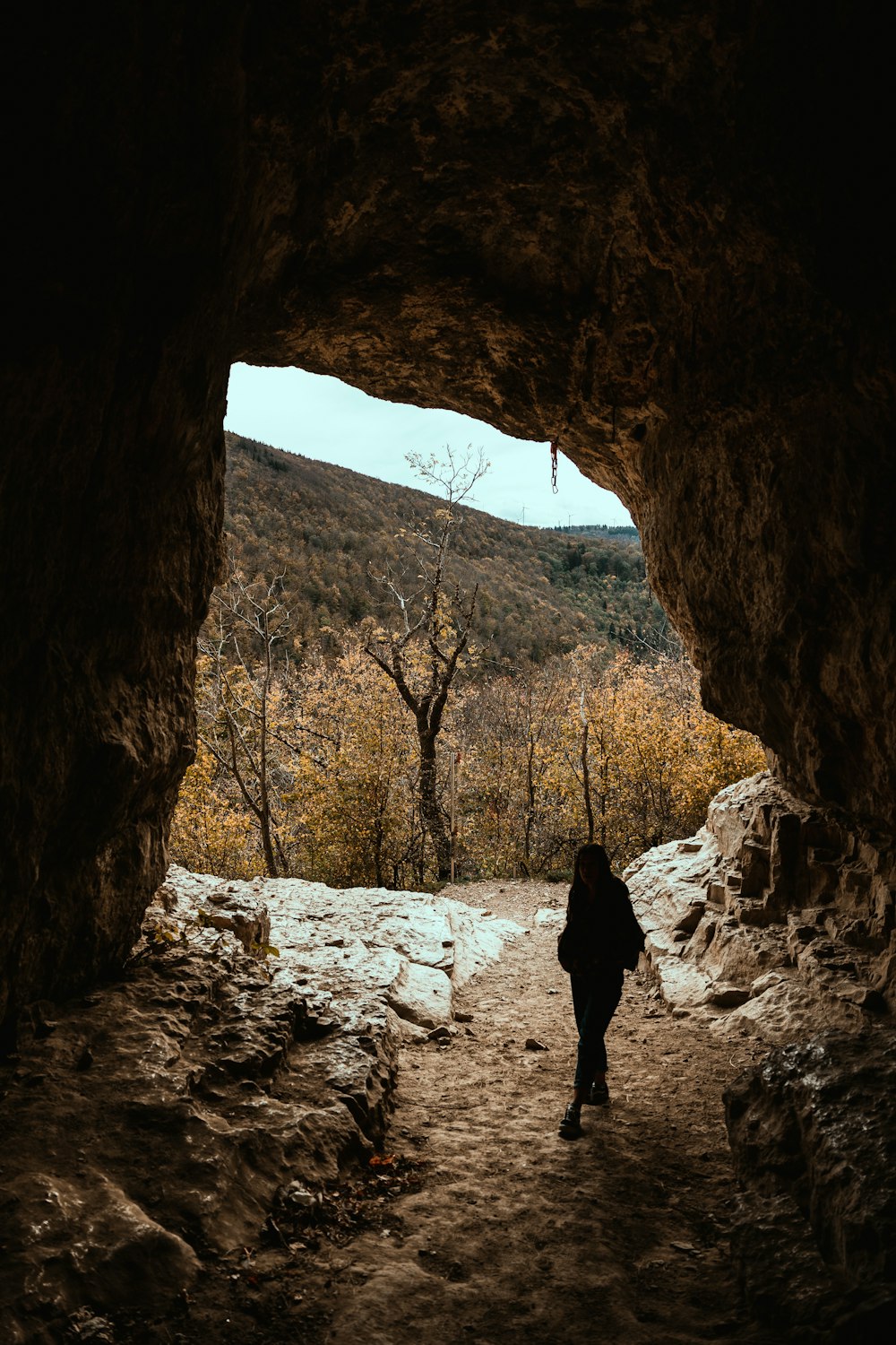 a person walking through a cave