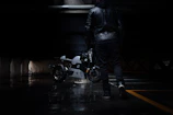 Urban model wearing a premium leather jacket walking through city streets at dusk.