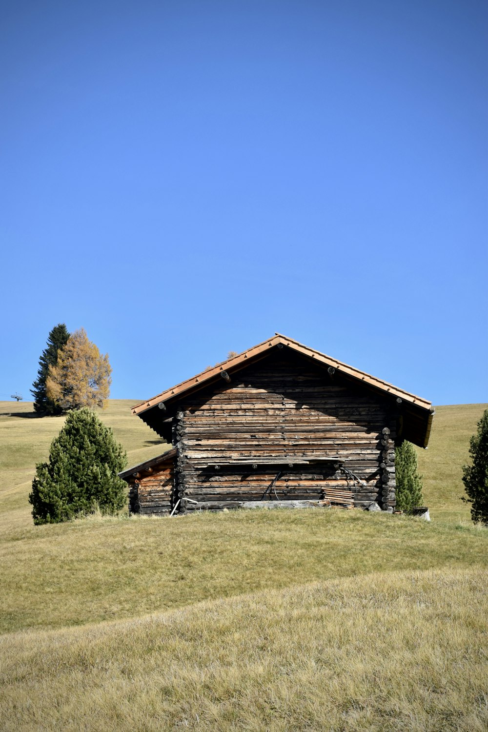 a wood building in a field