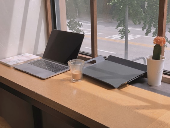 a laptop and a glass of water on a table
