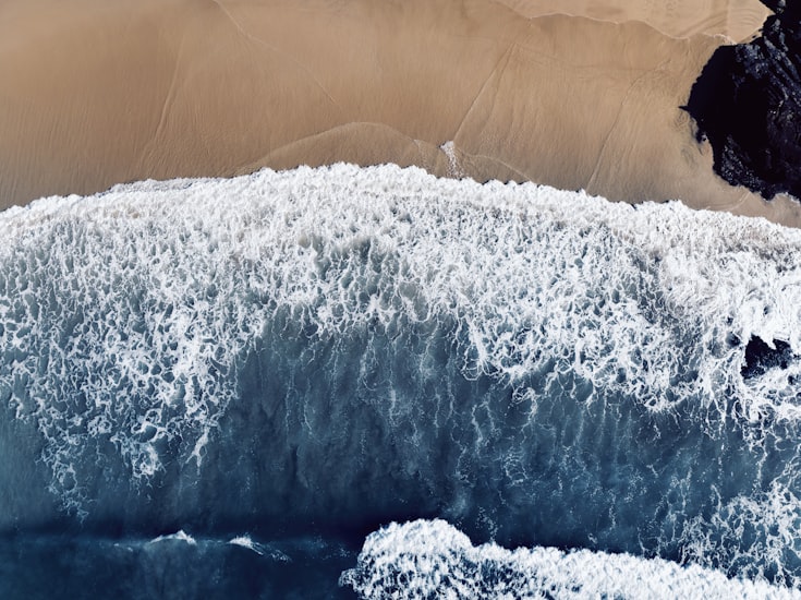 Wild surf beach below the cliffs at Gwenver, Sennen