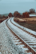 a railroad track with snow on the ground