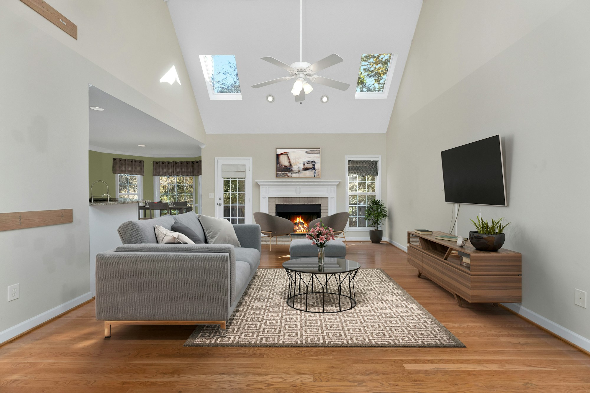Vacation rental living room with a fireplace, set up for a group of overnight guests