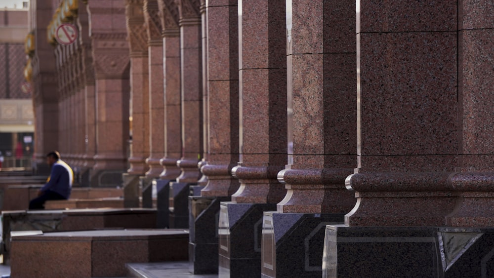 a person sitting on a bench in a large building