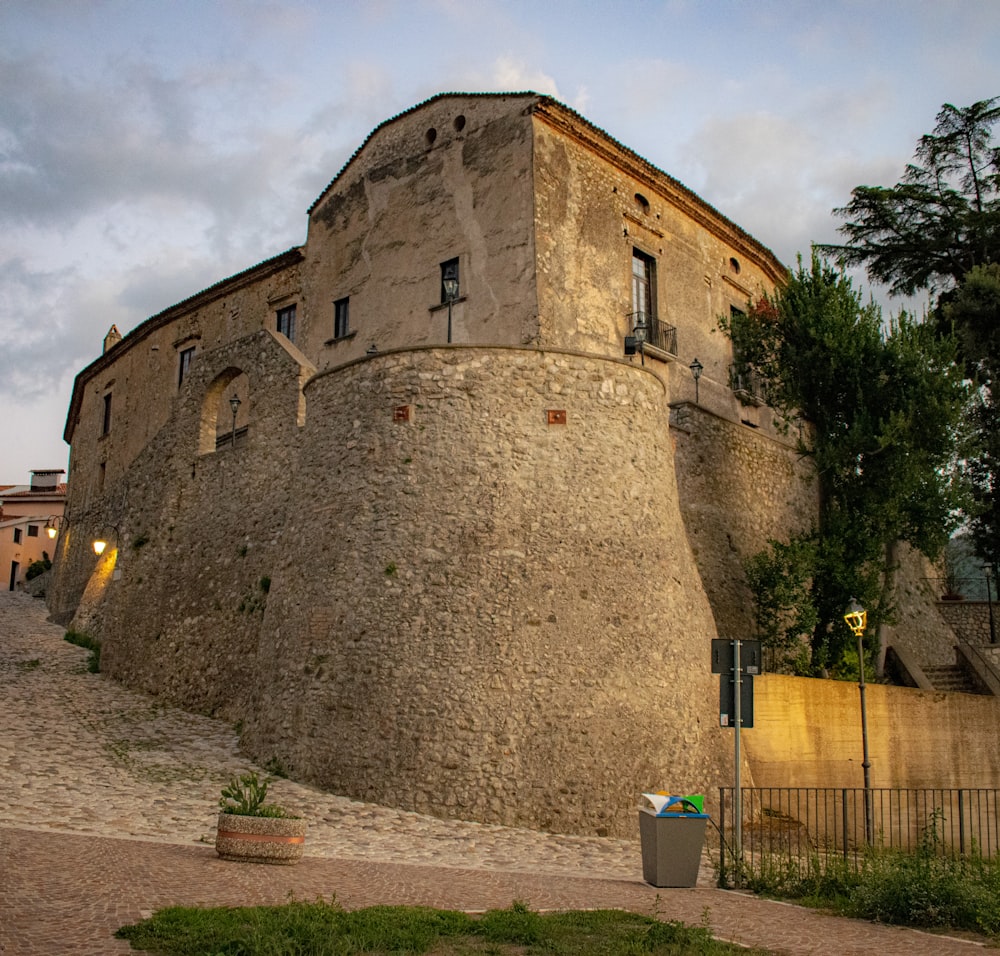 a stone building with a fence around it