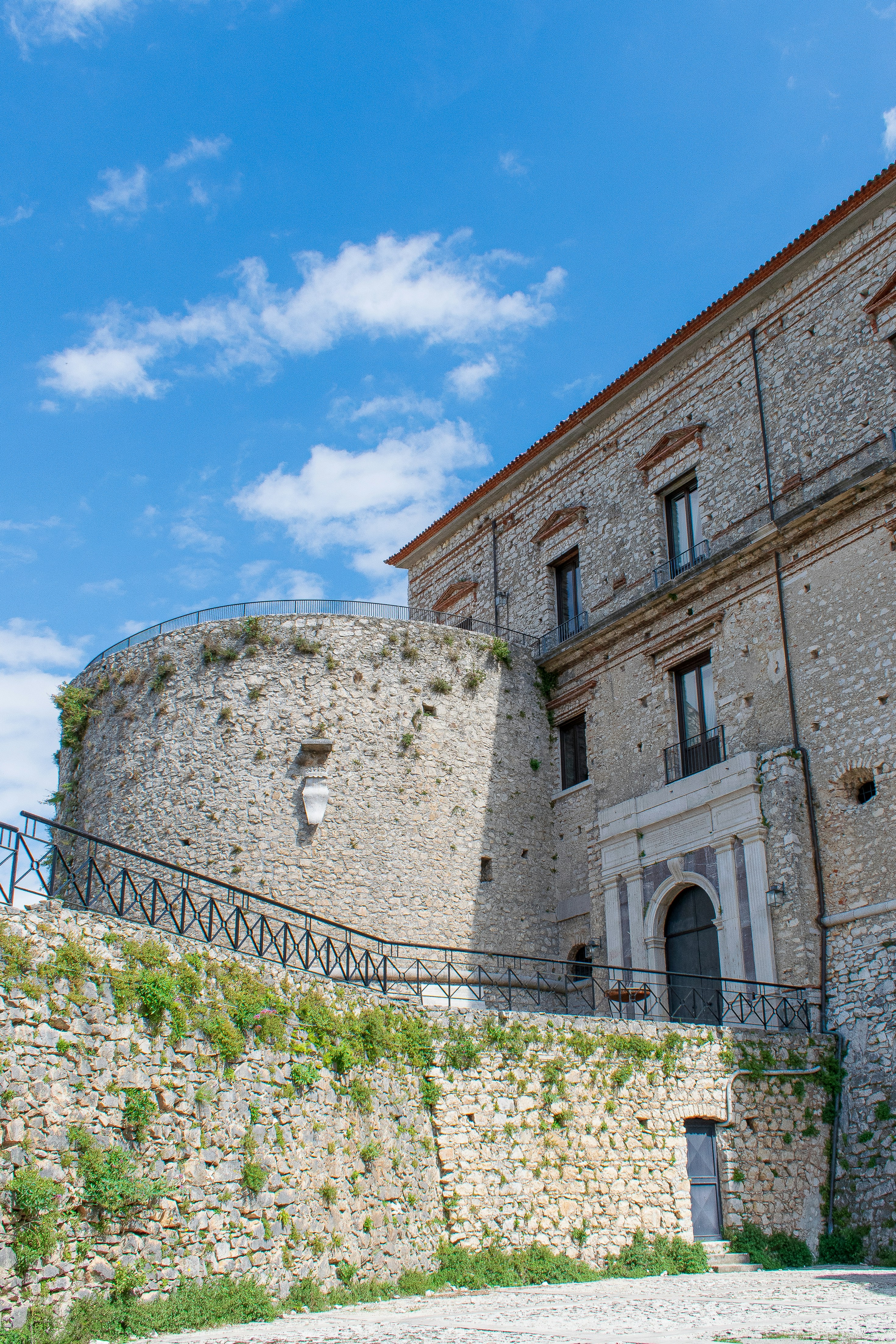 a stone building with a stone wall