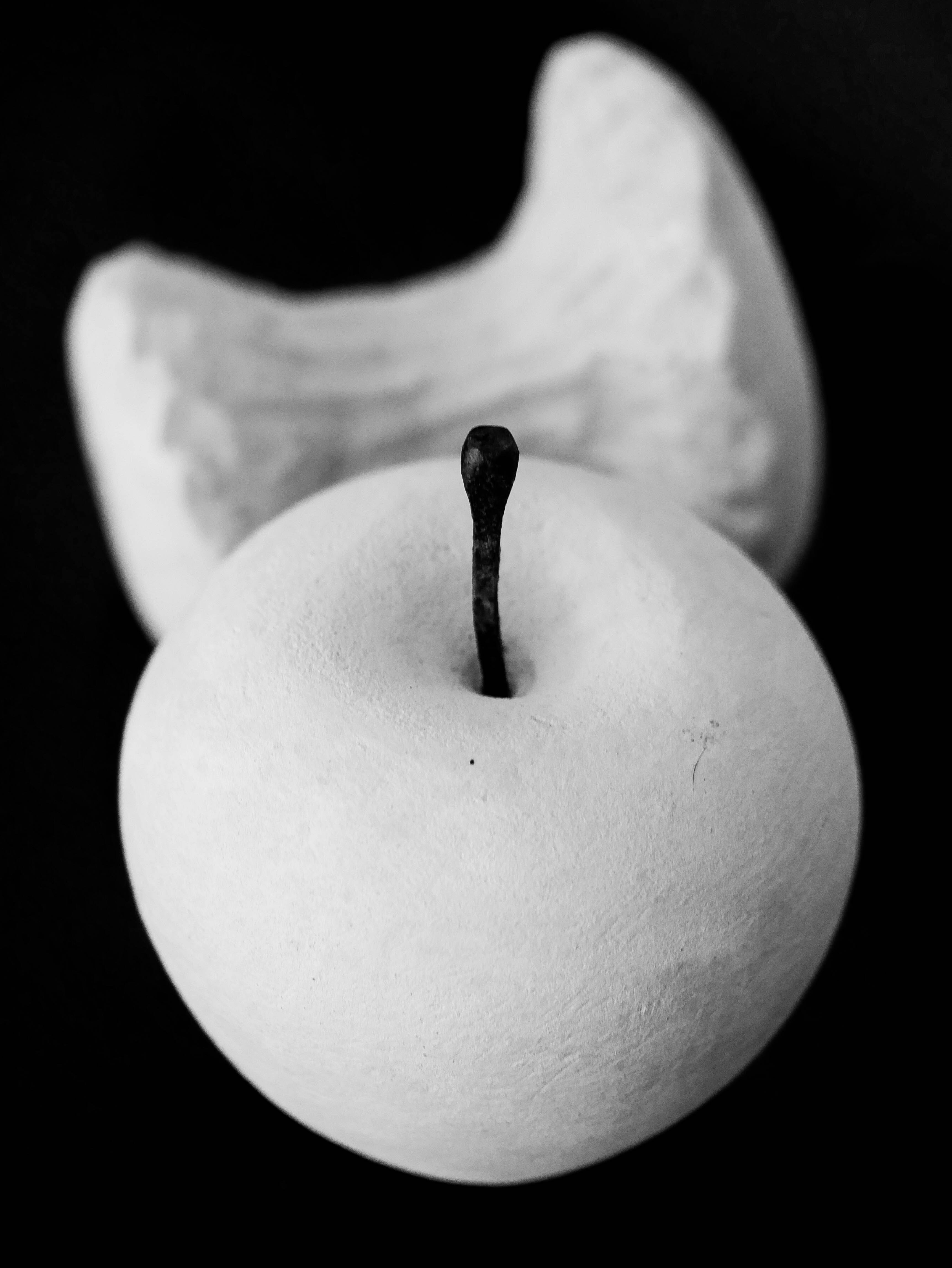 a white apple with a stem