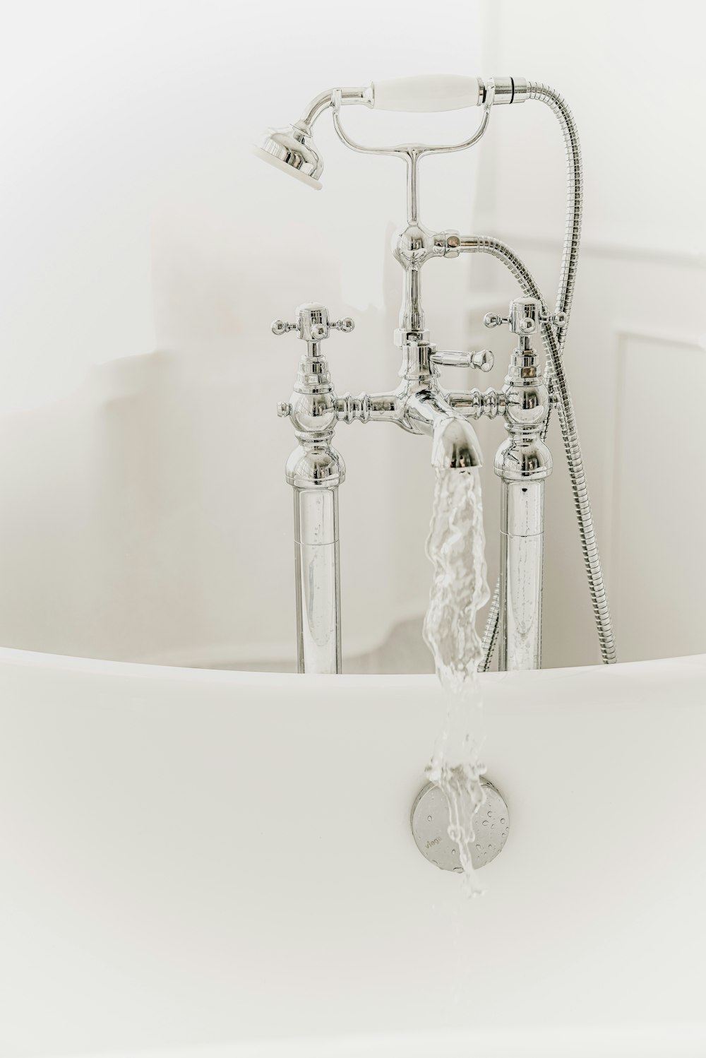 a shower head with a silver chain