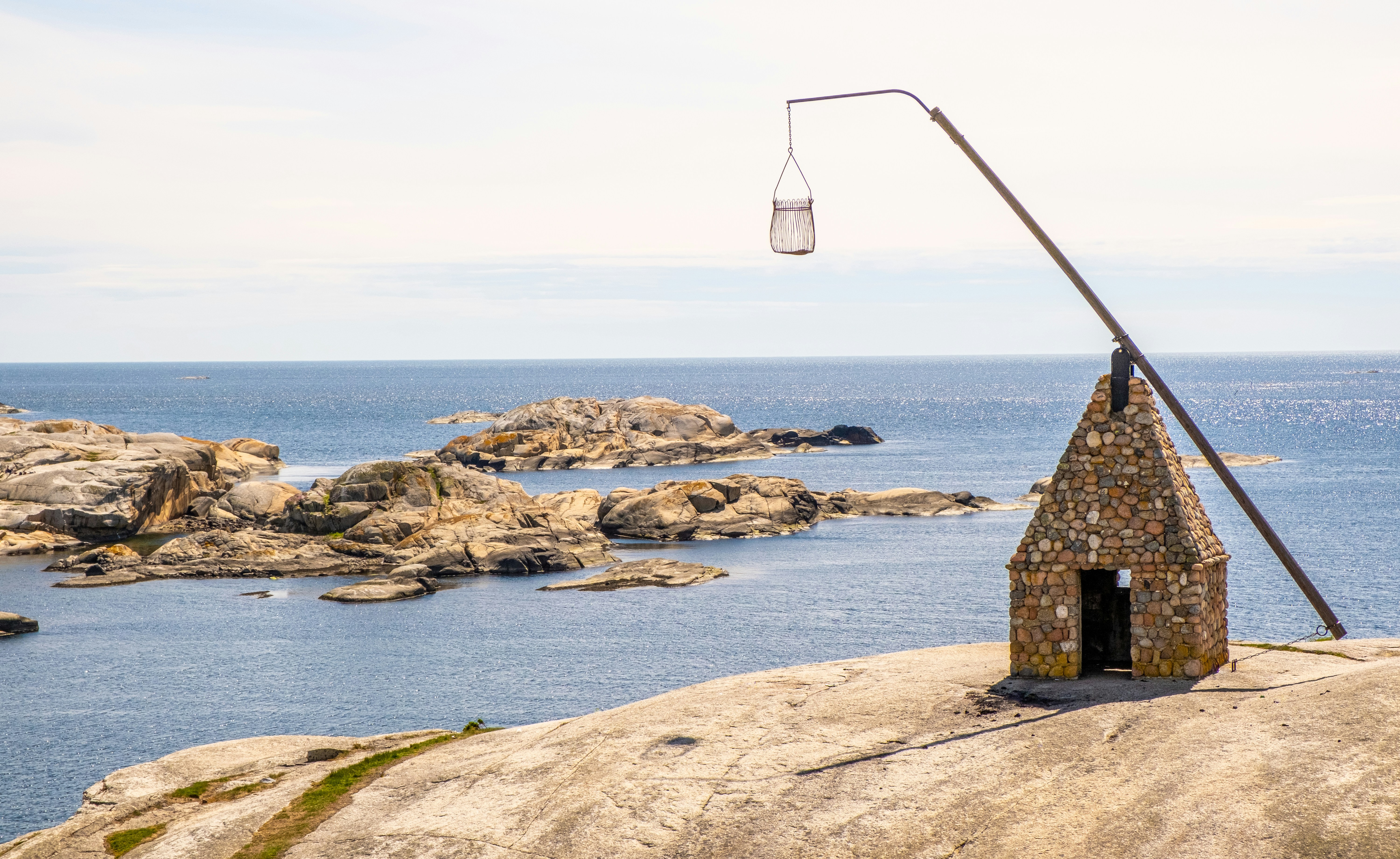 a stone structure on a rocky beach