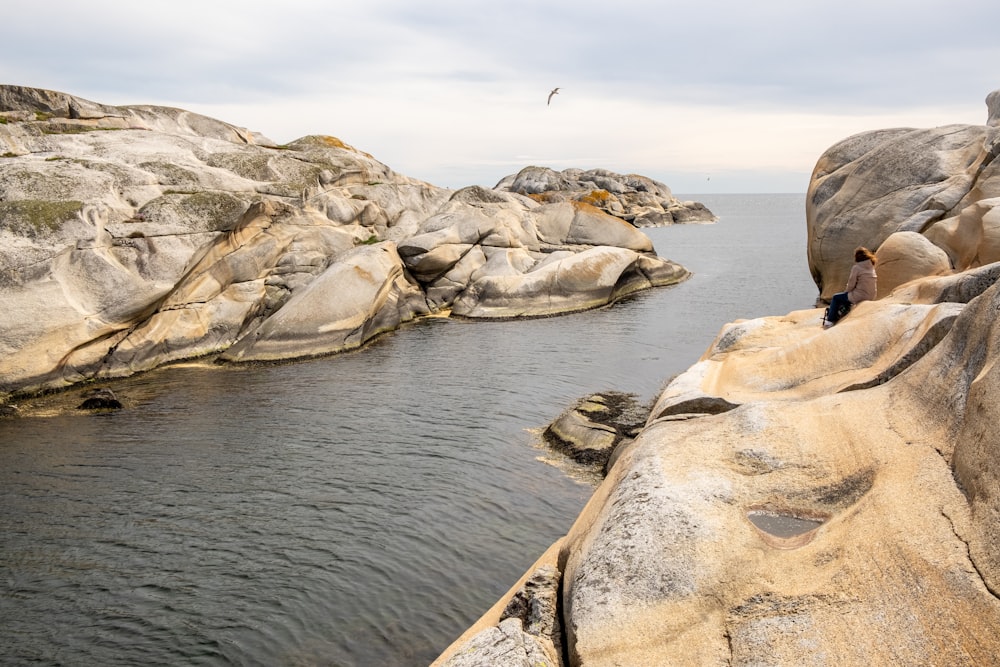 a group of people on a rocky shore