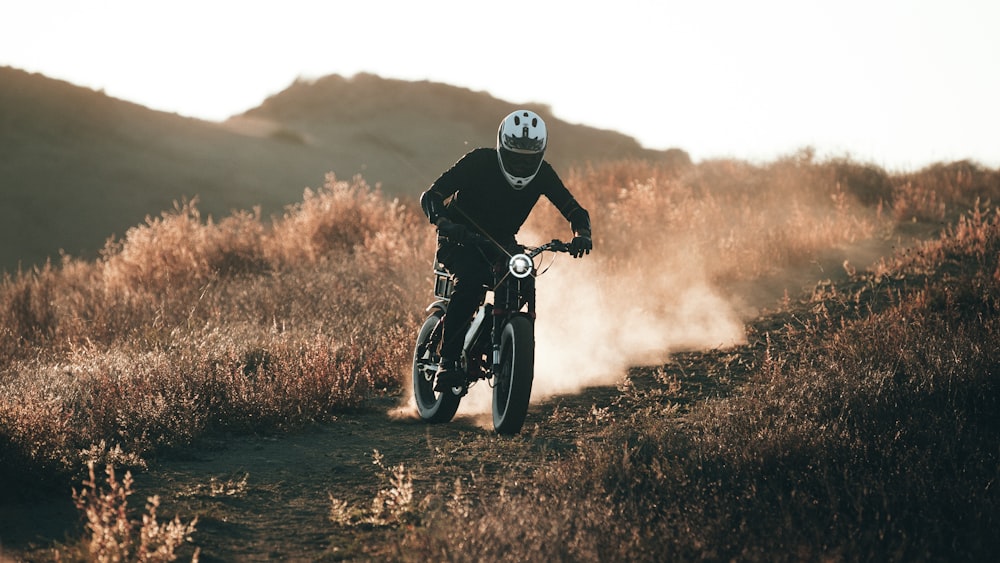 a person riding a motorcycle on a dirt road