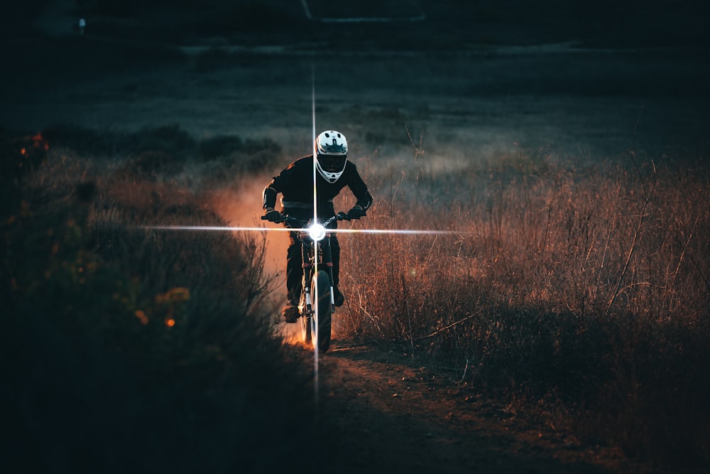 a person riding a bike in a field