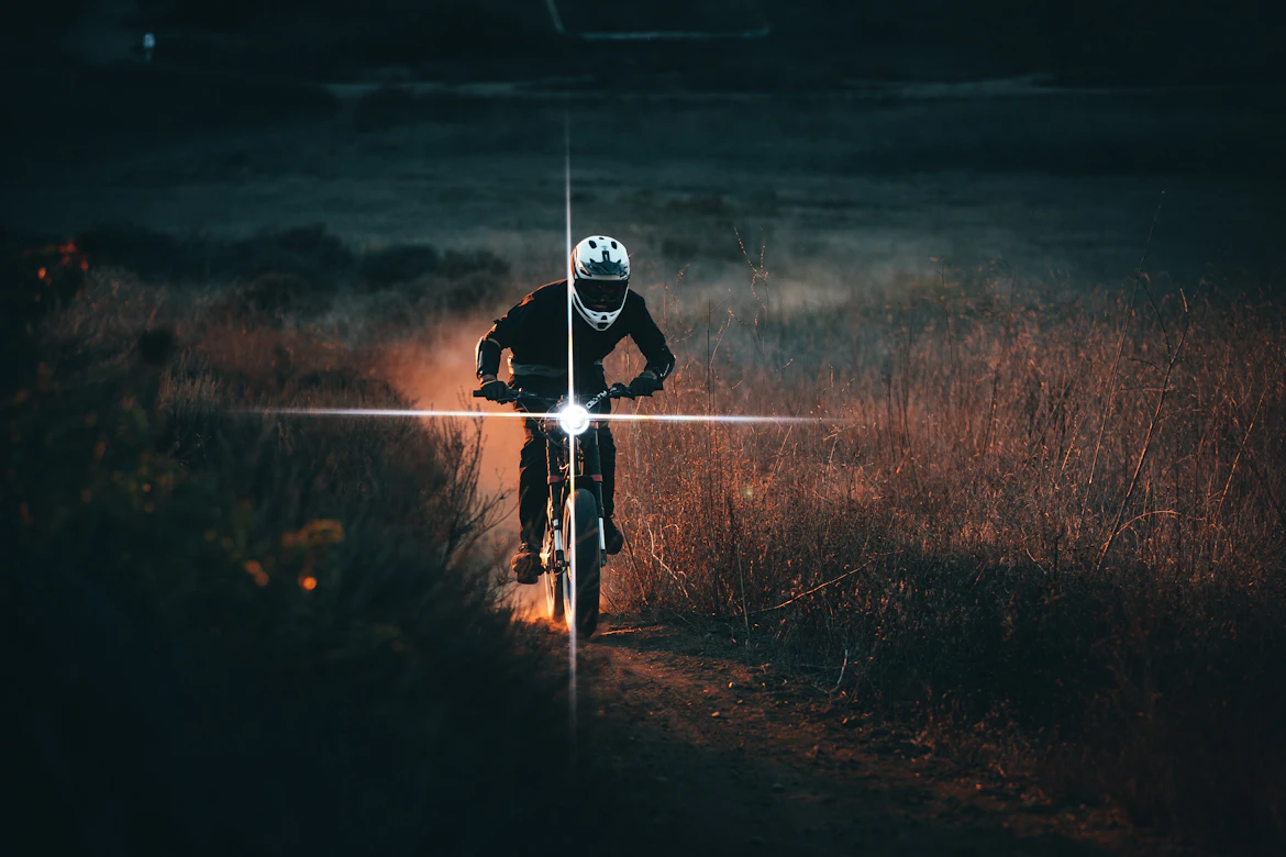 Cyclist riding on a city street after dark
