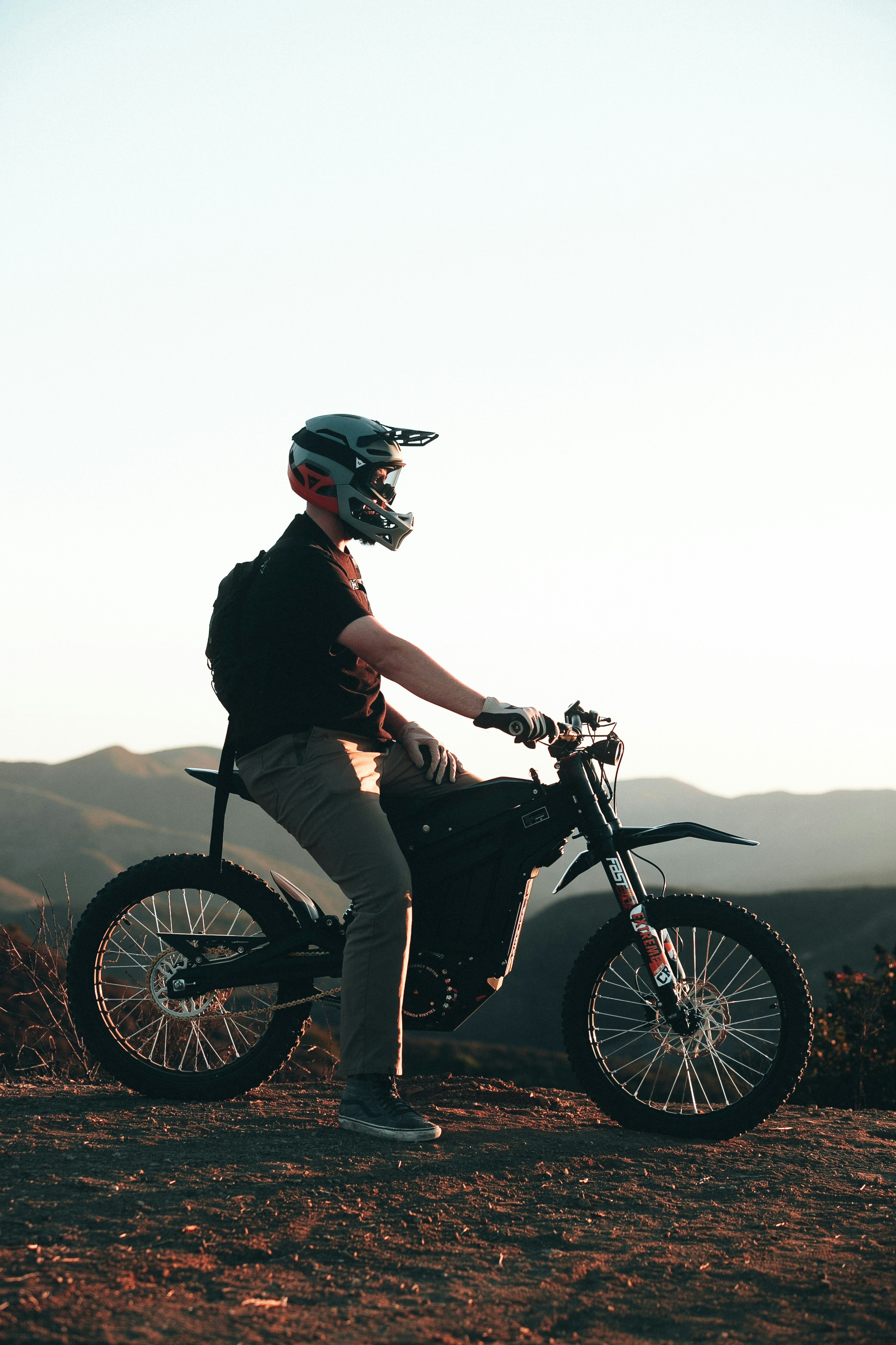 A close-up shot of a biker's helmet reflecting a beautiful sunset.