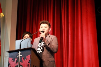 A portrait of a confident politician speaking at a podium.