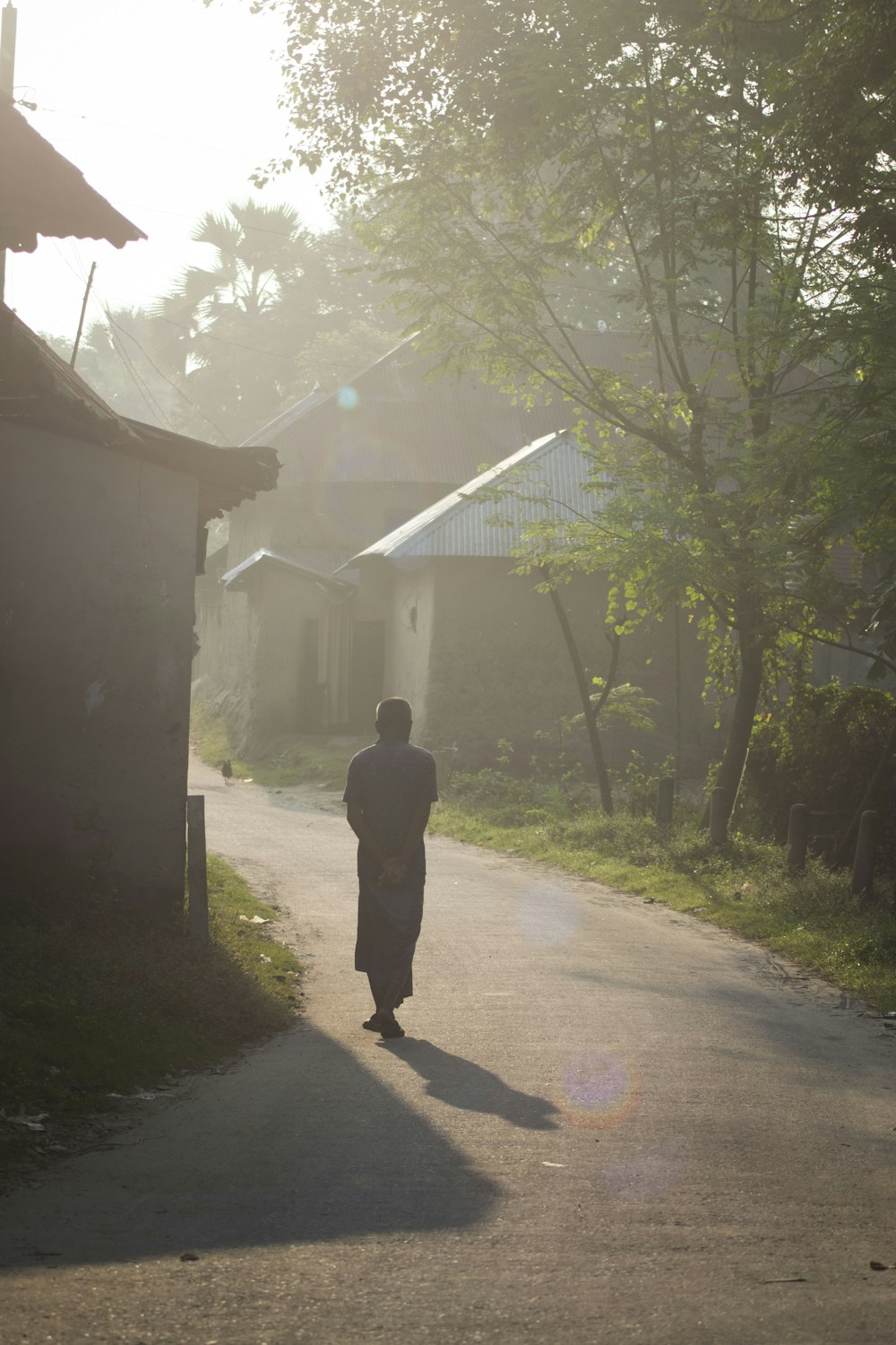 a man walking down a dirt road