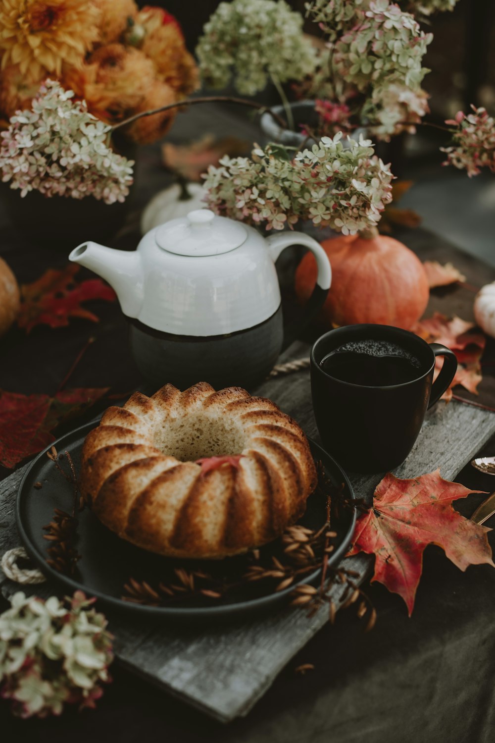 a plate of food and a teapot on a table