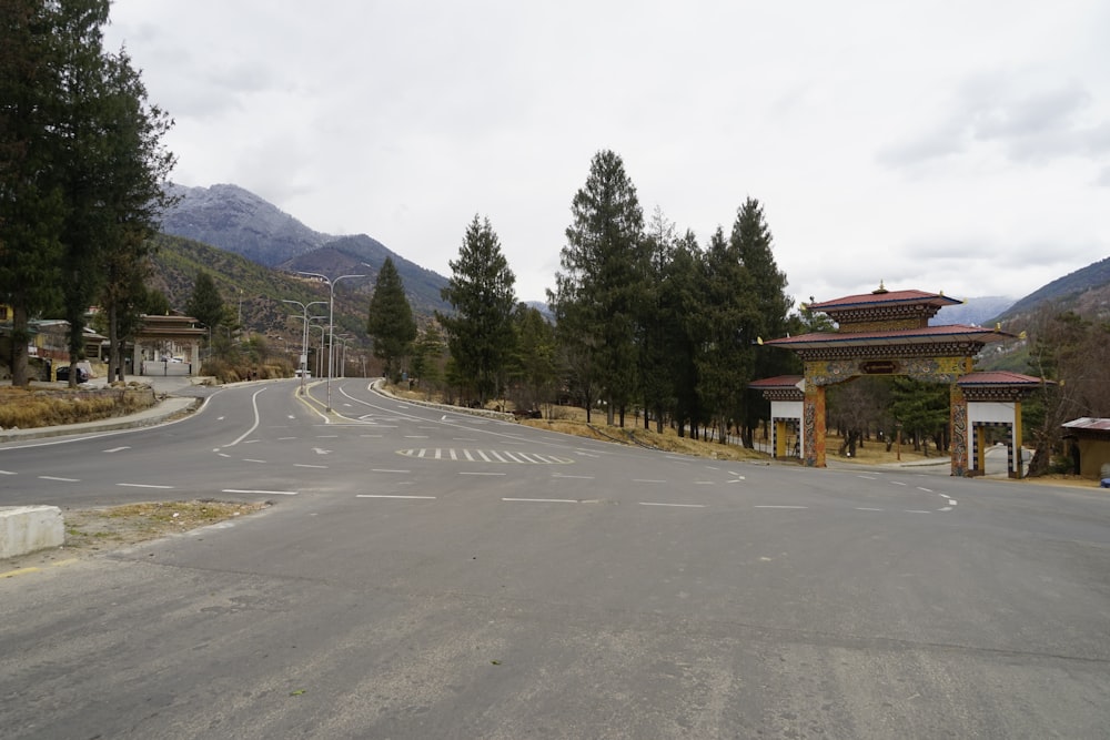 a road with trees and buildings on the side