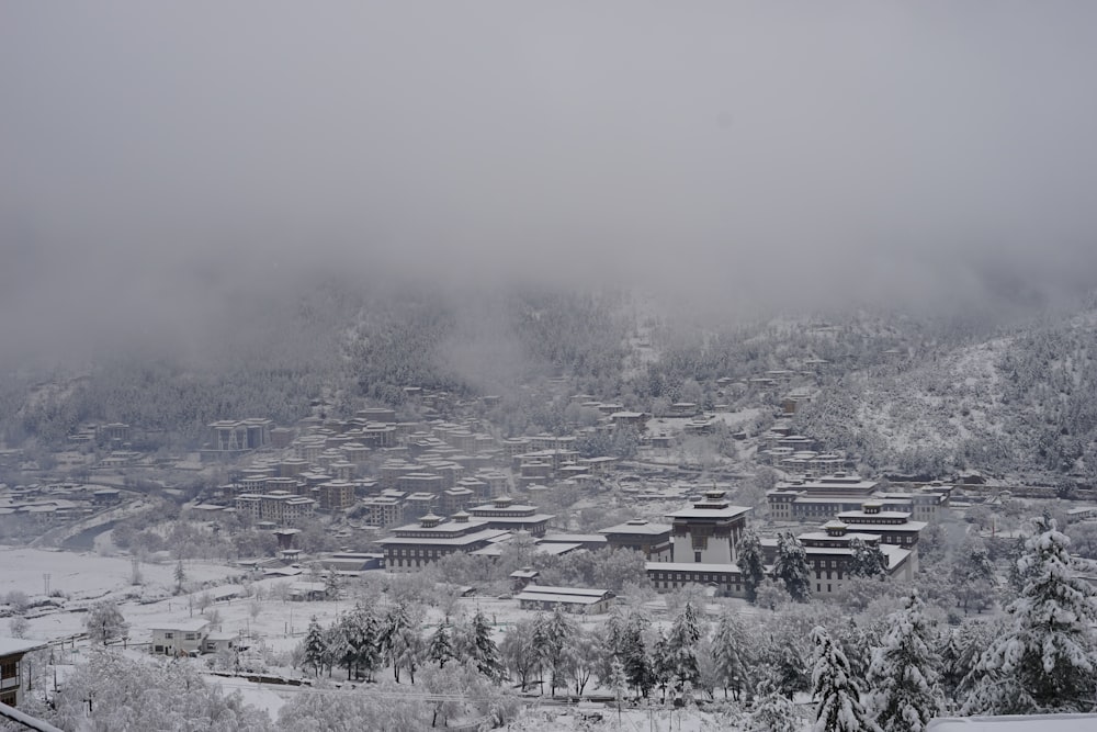 a black and white photo of a town in the snow