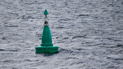 a green buoy in the water