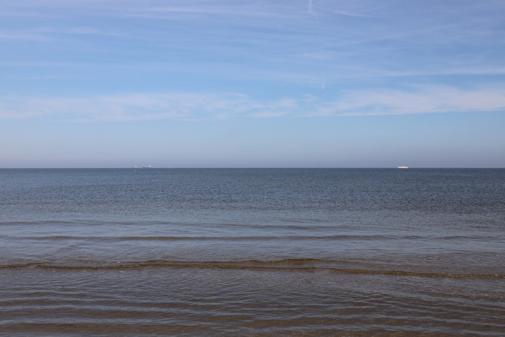 a body of water with a beach and land in the distance