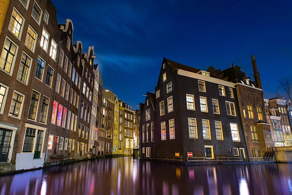 a row of buildings with lights on