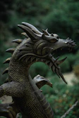 Close-up of a finely detailed dragon miniature with shimmering scales and fierce eyes.