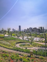 Community park with winding paths and diverse greenery, designed for social interaction and wellbeing.