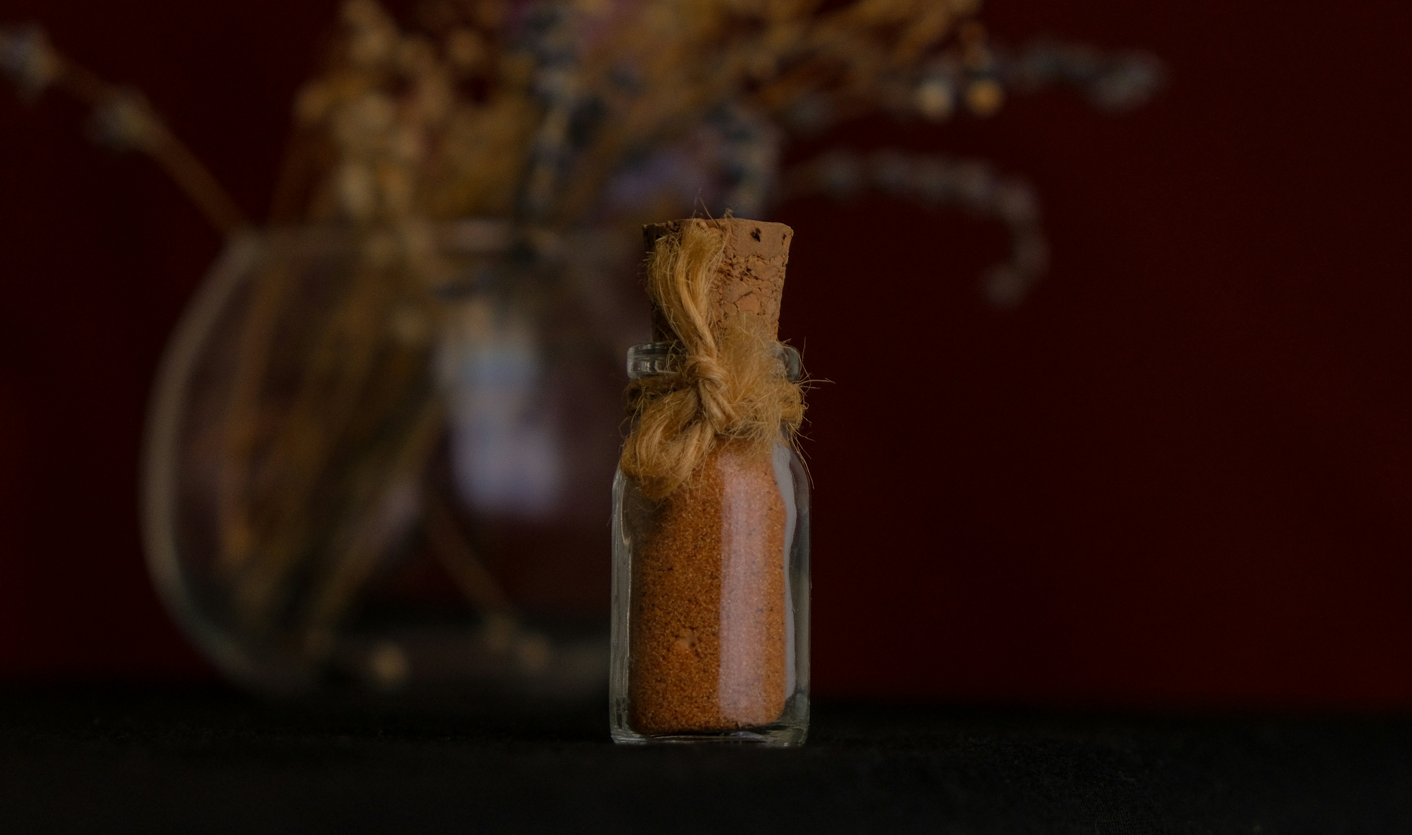 a glass of liquid with a brown liquid in it