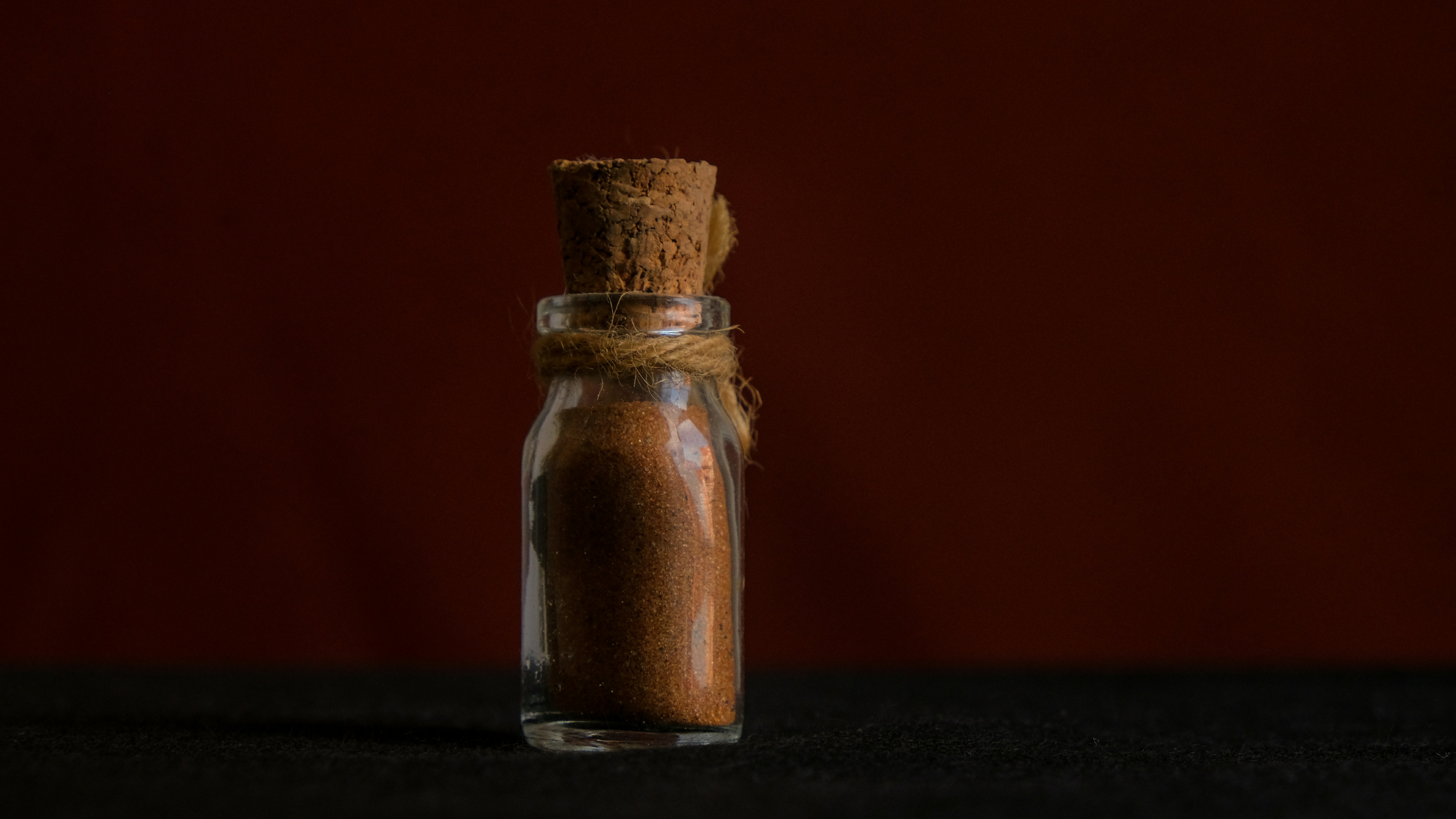 a glass bottle with a brown liquid